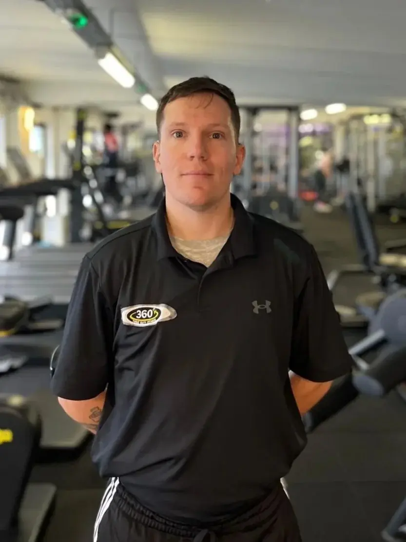 A personal trainer in a Three Sixty Fitness polo shirt